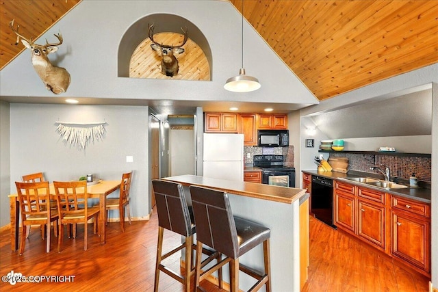 11091 Crestline Ln, Clam Gulch, AK 99568 - kitchen with black appliances, a sink, light wood finished floors, decorative backsplash, and wood ceiling