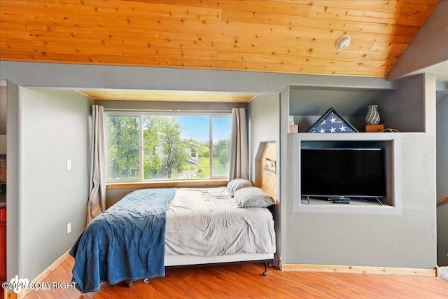 11091 Crestline Ln, Clam Gulch, AK 99568 - bedroom with lofted ceiling, wood finished floors, and baseboards
