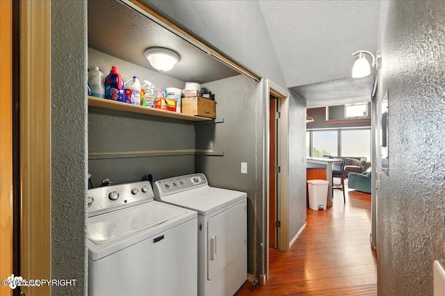 11091 Crestline Ln, Clam Gulch, AK 99568 - laundry room with a textured wall, washing machine and dryer, wood finished floors, and a textured ceiling