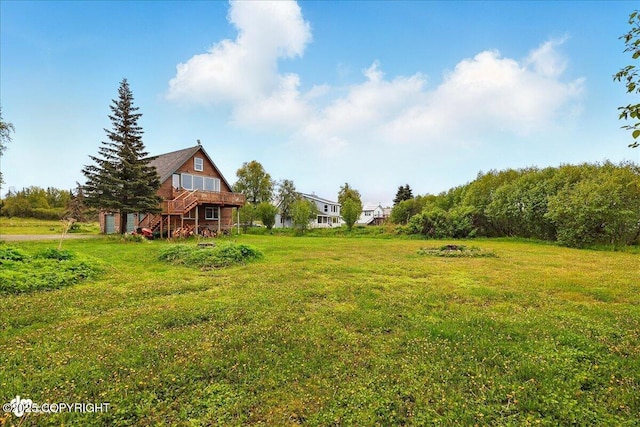 11091 Crestline Ln, Clam Gulch, AK 99568 - view of grassy yard featuring a wooden deck and stairs