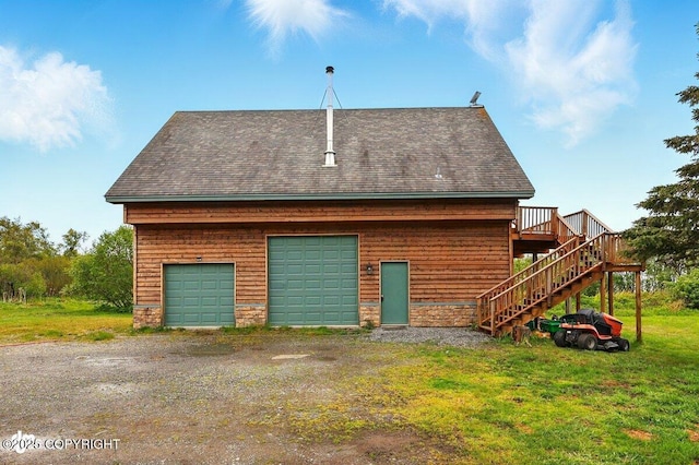 11091 Crestline Ln, Clam Gulch, AK 99568 - rear view of property featuring a garage, roof with shingles, stairway, and a wooden deck