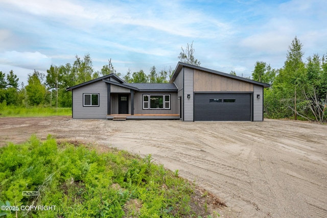 8328 S Ira Dr, Wasilla, AK 99623 - mid-century modern home featuring dirt driveway and a garage