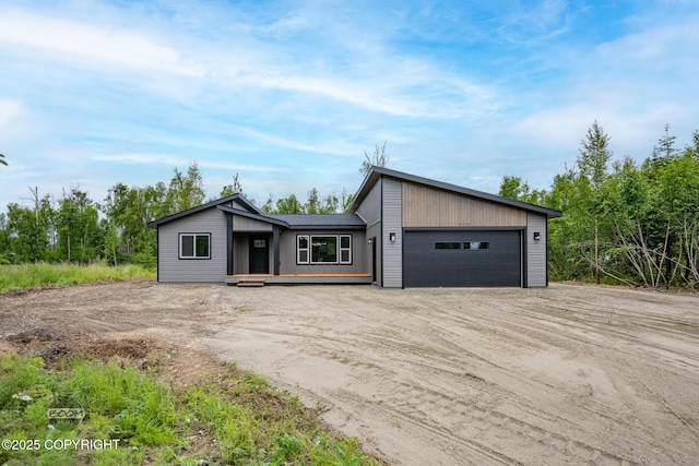8328 S Ira Dr, Wasilla, AK 99623 - mid-century modern home featuring dirt driveway and an attached garage