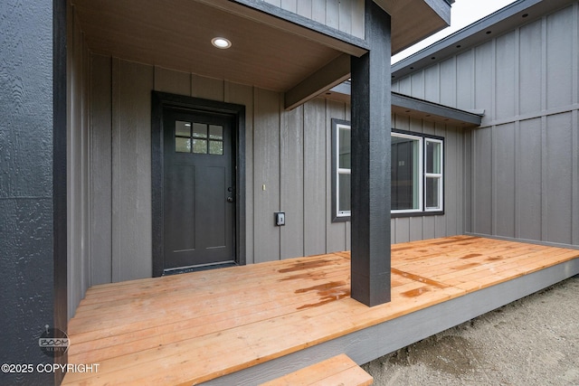 8328 S Ira Dr, Wasilla, AK 99623 - property entrance featuring a deck and board and batten siding