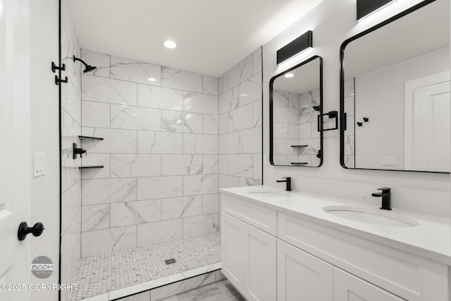 8328 S Ira Dr, Wasilla, AK 99623 - bathroom with double vanity, tiled shower, recessed lighting, and marble look tiles