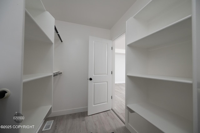 8328 S Ira Dr, Wasilla, AK 99623 - walk in closet featuring wood finished floors