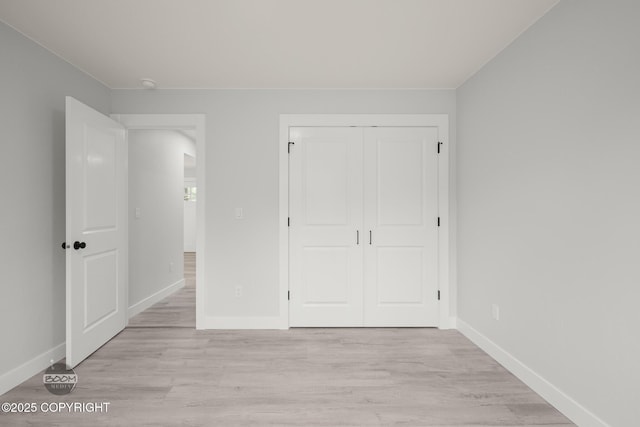 8328 S Ira Dr, Wasilla, AK 99623 - unfurnished bedroom featuring light wood-style flooring and a closet