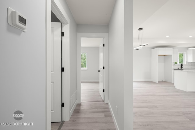 8328 S Ira Dr, Wasilla, AK 99623 - corridor featuring light wood finished floors, plenty of natural light, and recessed lighting