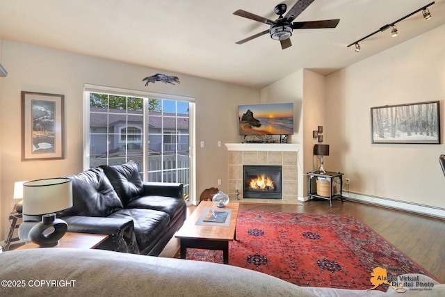 201 E Danna Ave Unit D, Wasilla, AK 99654 - living area featuring rail lighting, wood finished floors, baseboard heating, a ceiling fan, and a tile fireplace