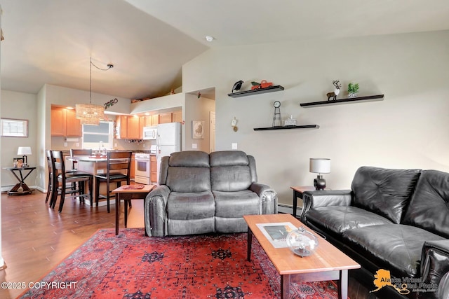 201 E Danna Ave Unit D, Wasilla, AK 99654 - living area featuring baseboard heating, vaulted ceiling, wood finished floors, and a chandelier