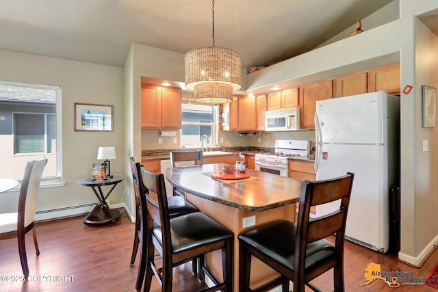201 E Danna Ave Unit D, Wasilla, AK 99654 - dining room with dark wood-type flooring, a chandelier, baseboard heating, and baseboards