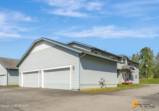 201 E Danna Ave Unit D, Wasilla, AK 99654 - view of side of property with asphalt driveway and a garage