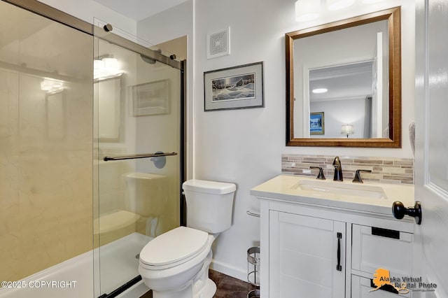 17132 Carl St, Anchorage, AK 99516 - full bathroom featuring vanity, a stall shower, toilet, decorative backsplash, and baseboards