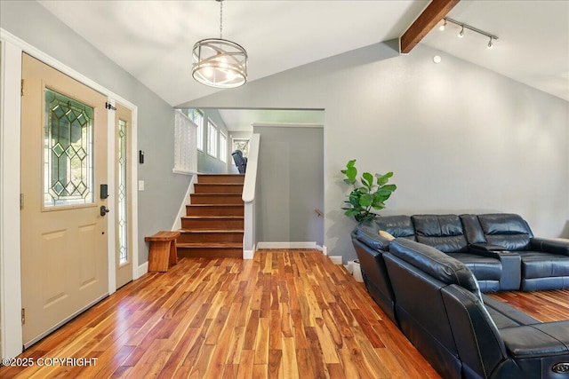 9701 Homestead Trl, Anchorage, AK 99507 - entrance foyer featuring light wood-style floors, stairs, and rail lighting