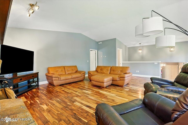 9701 Homestead Trl, Anchorage, AK 99507 - living area featuring vaulted ceiling, wood finished floors, and baseboards
