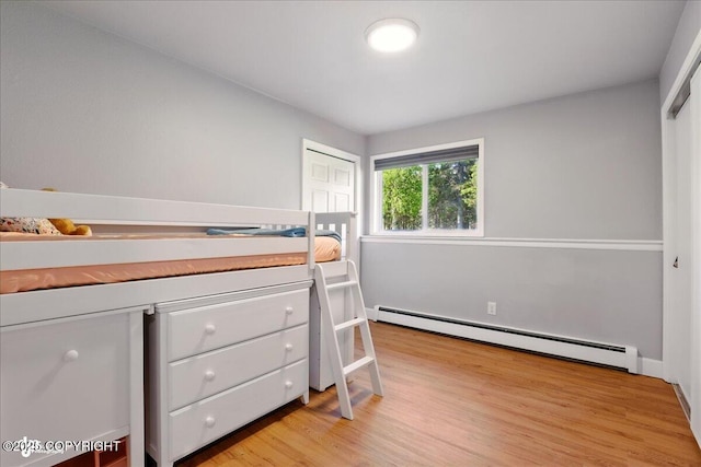 9701 Homestead Trl, Anchorage, AK 99507 - bedroom with a baseboard heating unit and light wood-type flooring