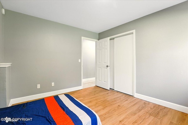 9701 Homestead Trl, Anchorage, AK 99507 - unfurnished bedroom with wood finished floors, baseboards, and a closet