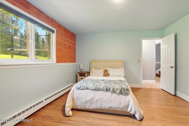 9701 Homestead Trl, Anchorage, AK 99507 - bedroom with a baseboard radiator, wood finished floors, and baseboards