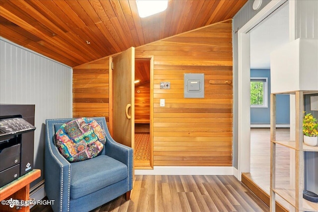 9701 Homestead Trl, Anchorage, AK 99507 - sitting room featuring a baseboard heating unit, wood finished floors, wooden walls, and wooden ceiling