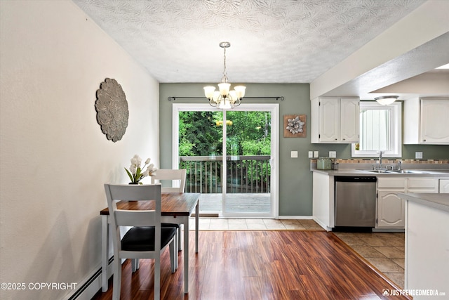 11730 Nix Ct, Anchorage, AK 99515 - kitchen with dishwasher, a sink, a chandelier, white cabinetry, and pendant lighting