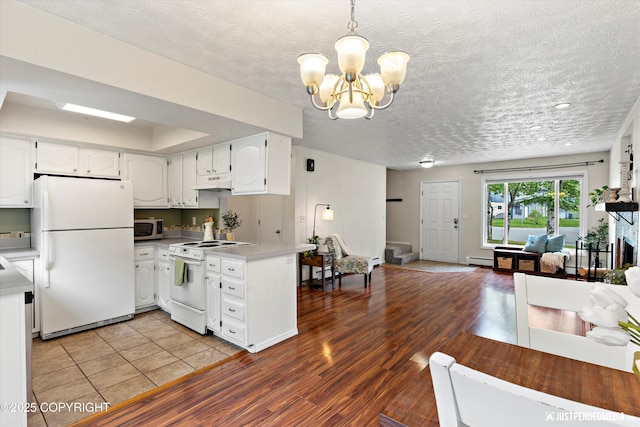 11730 Nix Ct, Anchorage, AK 99515 - kitchen featuring white appliances, open floor plan, under cabinet range hood, white cabinets, and light countertops
