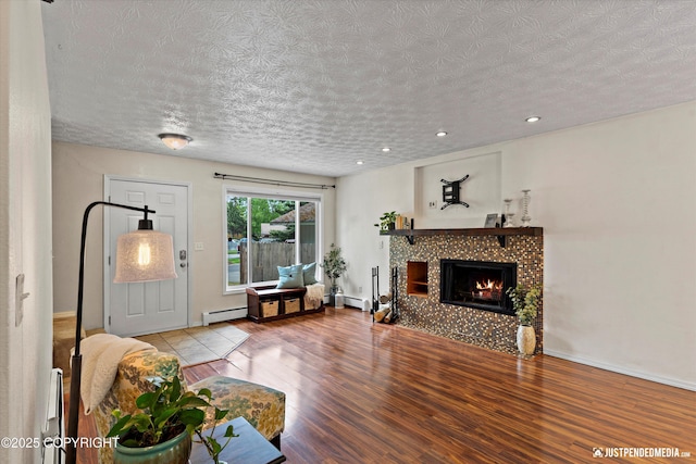 11730 Nix Ct, Anchorage, AK 99515 - living room with wood finished floors, a baseboard radiator, a textured ceiling, a fireplace, and baseboards