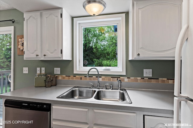 11730 Nix Ct, Anchorage, AK 99515 - kitchen featuring dishwasher, a sink, white refrigerator, and white cabinetry