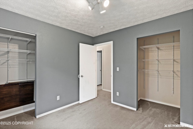 11730 Nix Ct, Anchorage, AK 99515 - unfurnished bedroom featuring a closet, carpet flooring, baseboards, and a textured ceiling