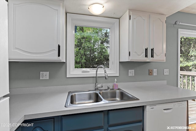 11730 Nix Ct, Anchorage, AK 99515 - kitchen with white dishwasher, a sink, white cabinets, and light countertops