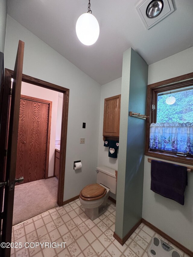 34008 Orlander Ave, Seward, AK 99664 - bathroom featuring toilet, lofted ceiling, baseboards, and tile patterned floors