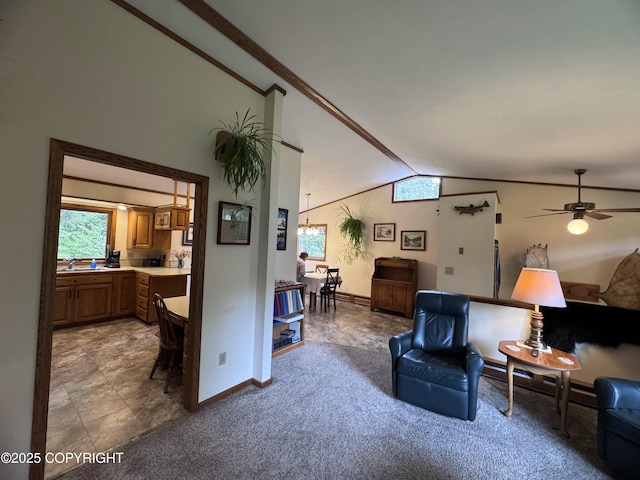 34008 Orlander Ave, Seward, AK 99664 - carpeted living room featuring vaulted ceiling, baseboards, a ceiling fan, and a sink