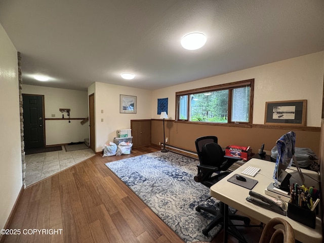 34008 Orlander Ave, Seward, AK 99664 - office with a baseboard radiator and wood finished floors