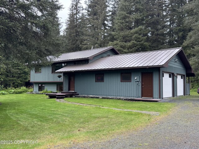 34008 Orlander Ave, Seward, AK 99664 - view of front of house with a front lawn, a garage, metal roof, and a standing seam roof