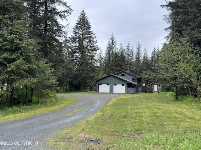 34008 Orlander Ave, Seward, AK 99664 - view of front facade with a front yard, driveway, a view of trees, stairway, and a garage