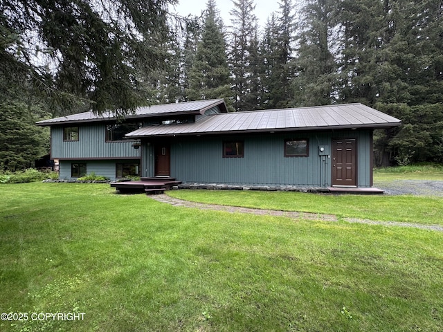 34008 Orlander Ave, Seward, AK 99664 - view of front of home featuring a front lawn, metal roof, and a garage