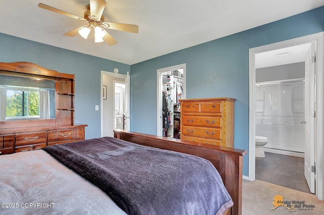 962 S Rebecca Dr, Palmer, AK 99645 - carpeted bedroom featuring a walk in closet, ensuite bath, a closet, and a ceiling fan