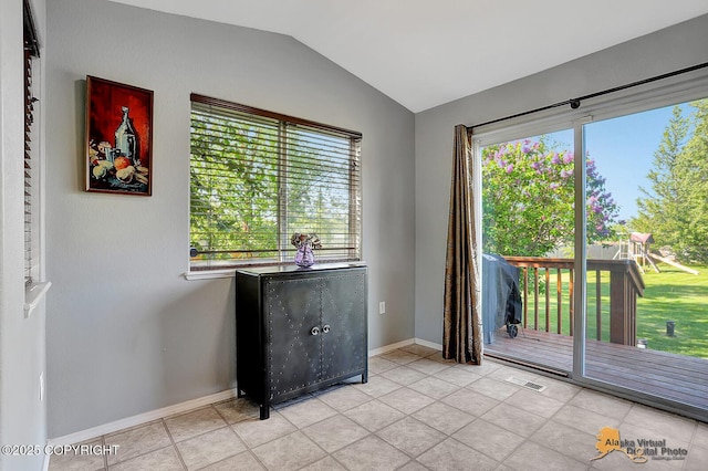 962 S Rebecca Dr, Palmer, AK 99645 - spare room with vaulted ceiling, healthy amount of natural light, and light tile patterned floors