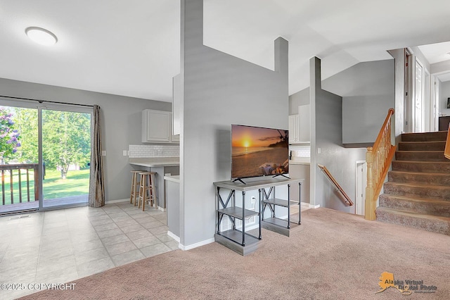 962 S Rebecca Dr, Palmer, AK 99645 - living room featuring light colored carpet, stairway, and high vaulted ceiling