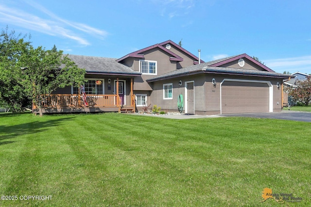 962 S Rebecca Dr, Palmer, AK 99645 - split level home featuring a front yard, an attached garage, and asphalt driveway