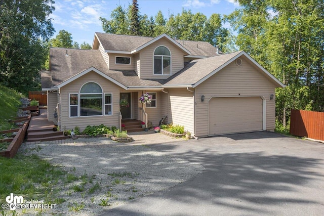 17231 Alice Loop, Eagle River, AK 99577 - view of front of house with asphalt driveway, a garage, and a shingled roof