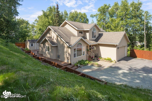 17231 Alice Loop, Eagle River, AK 99577 - view of front of property with a storage unit, asphalt driveway, and a shingled roof