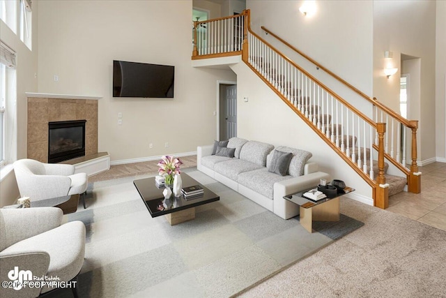 17231 Alice Loop, Eagle River, AK 99577 - tiled living area with a towering ceiling, carpet floors, stairway, and a tiled fireplace