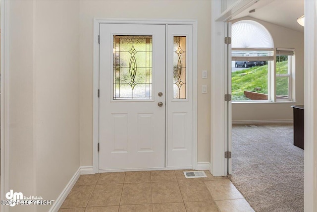 17231 Alice Loop, Eagle River, AK 99577 - entrance foyer with light tile patterned floors, light colored carpet, and lofted ceiling