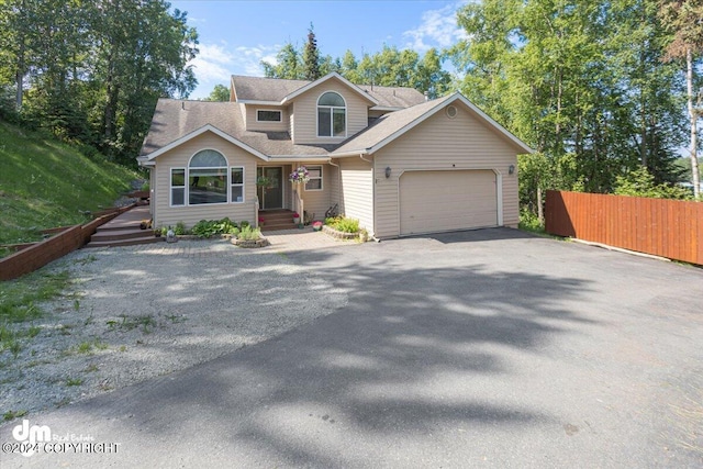 17231 Alice Loop, Eagle River, AK 99577 - view of front facade featuring driveway, an attached garage, and roof with shingles