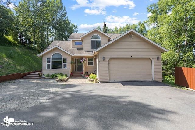 17231 Alice Loop, Eagle River, AK 99577 - view of front of home featuring driveway, a garage, and roof with shingles