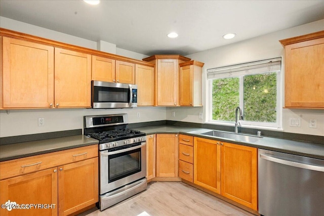 17231 Alice Loop, Eagle River, AK 99577 - kitchen with stainless steel appliances, light wood-style floors, dark countertops, and recessed lighting