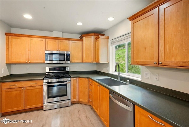 17231 Alice Loop, Eagle River, AK 99577 - kitchen with appliances with stainless steel finishes, light wood-type flooring, dark countertops, and recessed lighting