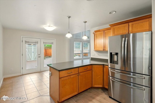 17231 Alice Loop, Eagle River, AK 99577 - kitchen with stainless steel fridge with ice dispenser, a peninsula, dark countertops, french doors, and brown cabinetry