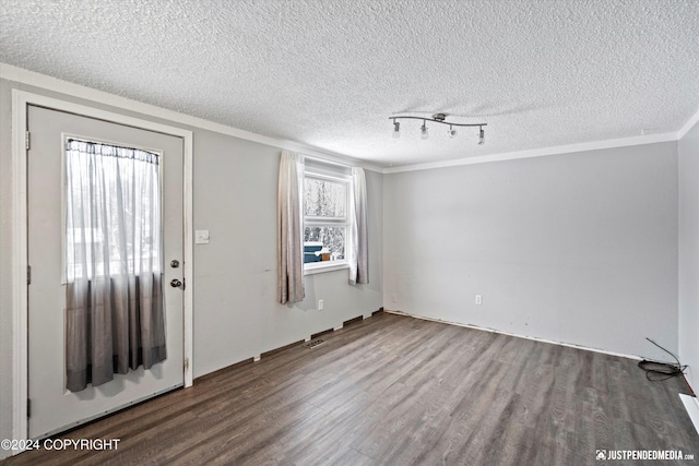 19237 Beverly Ave, Chugiak, AK 99567 - entryway with wood finished floors, a textured ceiling, and ornamental molding