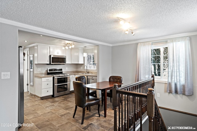 19237 Beverly Ave, Chugiak, AK 99567 - dining area featuring a textured ceiling and healthy amount of natural light